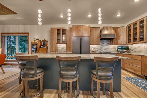 Modern bright pendant lights in addition to LED lighting and under counter lighting makes using this kitchen a dream!