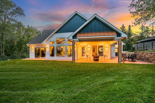 The lakeside outdoor living area acts as a true extension of the home, offering plenty of space for a full dining set, lounge seating for a resort like feeling.