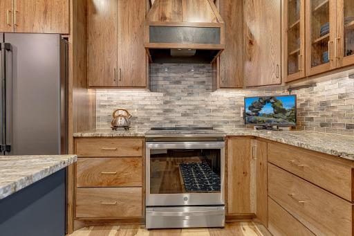 Top of the line GE induction electric range with custom range hood to add that "custom" look and feel.
