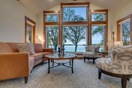 Lakefront wall of windows! Custom motorizered window treatments through out the home.