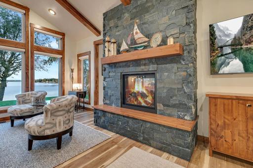 Contemporary floor-to-ceiling dry stacked dark slate-style stone, with Alder mantel.