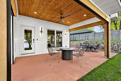 Custom masonry flooring flows around the corner of the house making hosting grand evenings or enjoying a quiet morning coffee, this seamless transition embodies true resort-style living.