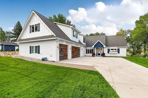 A massive clean-poured concrete driveway and turnaround space offers abundance of parking, lined with custom paver brickwork.