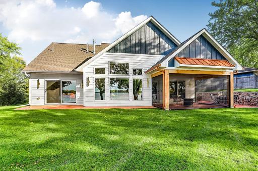 The heart of the lakeside facade features a massive wall of geometric windows that gives panoramic views of Lake Latoka. This home is an absolute masterpiece designed for effortless indoor-outdoor entertaining and luxury living.