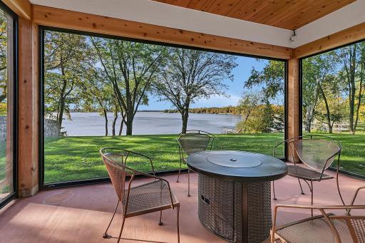 Enjoy this picture perfect view from your covered porch and accessed from your primary bedroom. Quickly turn this area into screened porch with a remote, screens go up or down!