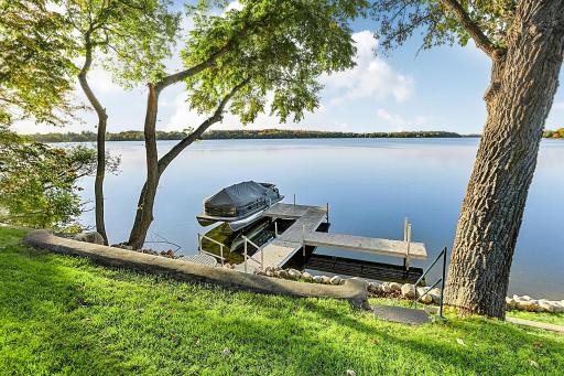 Breathtaking long view of lake Latoka with manicured lawn and gently slopes down to a 114FT of pristine shoreline. *The dock will stay with the property.