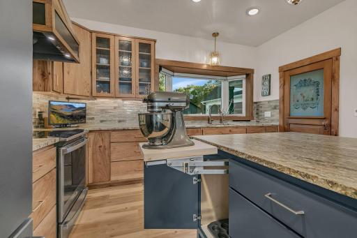 Highly functional island eequipped with a heavy-duty appliance mixer lift.