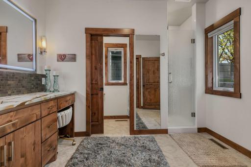 Luxurious primary bathroom entry showcases an elegant transition from the vanity area into an adjacent private water closet.