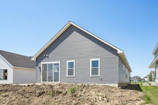 Rear Elevation - Price includes a concrete patio, irrigation system, landscaping, and sod. Welcome to the Eveleth Patio plan by Robert Thomas Homes. Photos are of similar home; options and features will vary.