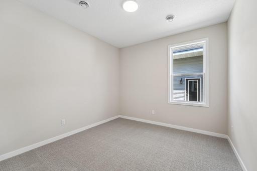 Bedroom 2. Welcome to the Eveleth Patio plan by Robert Thomas Homes. Photos are of similar home; options and features will vary.