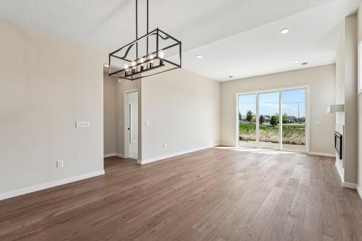 Dining / Gathering Room with large windows allowing natural light to come in. Photos are of similar home; options and features will vary.