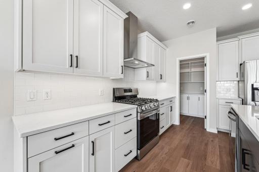 Beautiful white cabinetry and black accents. Photos are of similar home; options and features will vary.