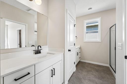 Primary Bathroom with dual sinks and a ton of storage space! Welcome to the Eveleth Patio plan by Robert Thomas Homes. Photos are of similar home; options and features will vary.