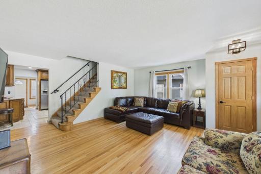 Living room in the main level with stairs leading to upper primary ensuite