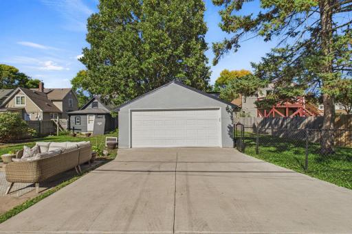 Newer concrete driveway leaving to the detached two car garage