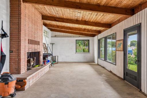 Full masonry wood-burning fireplace adds incredible potential to this unique waterfront space