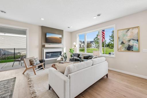 The gathering room fireplace will make the room nice and cozy on the cold days and nights. Photos are from similar home; colors, options and features will vary.
