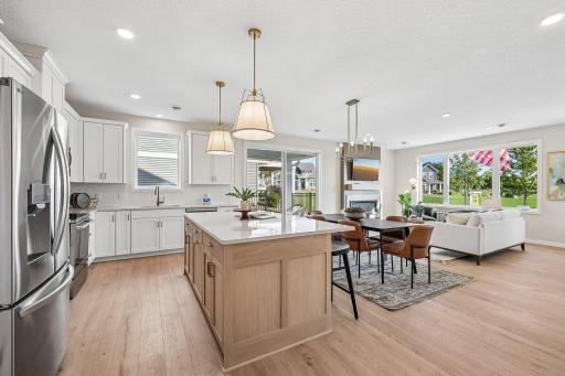 The kitchen island is ideal for all the meal prep and gatherings. Photos are from similar home; colors, options and features will vary.