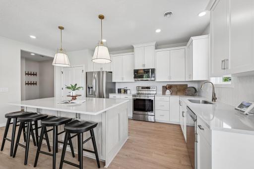 Beautiful kitchen with amazing finishes! LG stainless steel appliances, quartz countertops and ceramic tile backsplash. Photos are from similar home; colors, options and features will vary.