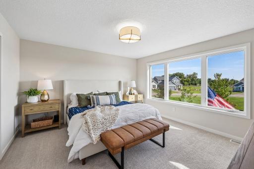 Primary bedroom. Photos are from similar home; colors, options and features will vary.