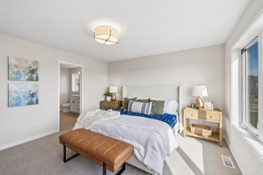 Primary bedroom with private owner's bath. Photos are from similar home; colors, options and features will vary.
