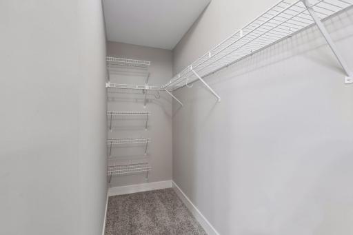 Primary bedroom walk in closet offers ample storage.