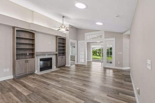 Built in shelves, gas fireplace, solar sky lights that illuminate the space & enjoy adjoining sunroom.