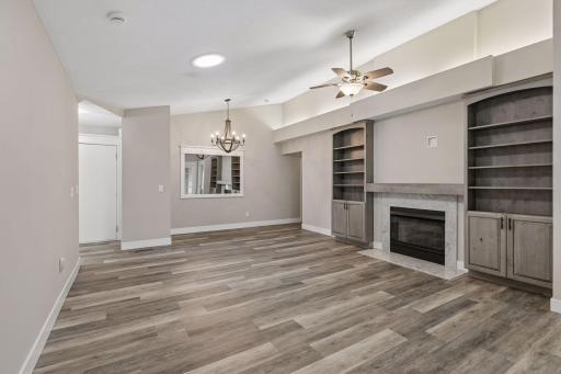 Living space complete with informal dining area, gas fireplace, vaulted ceilings, built in cabinetry and recessed lighting.