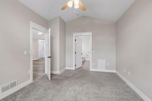 Primary bedroom with ensuite includes walk in closet, vaulted ceiling, jetted tub and separate shower.
