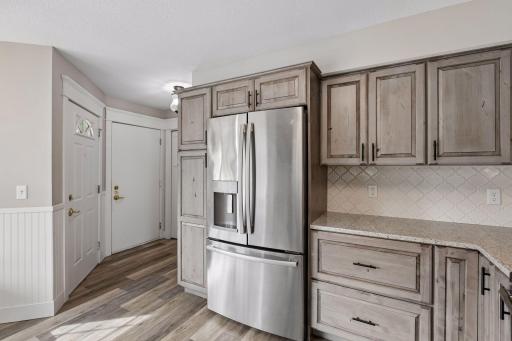 Upon entrance you'll be impressed to find luxury vinyl plank flooring throughout the main level living spaces, custom Alder cabinetry, enameled doors, granite countertops and stainless appliances.
