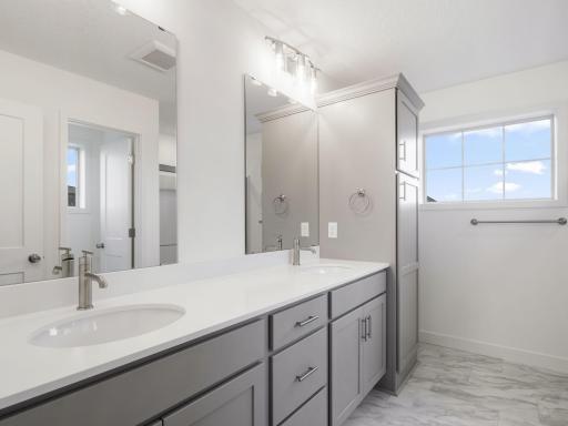Owner's bathroom with dual vanity and linen storage