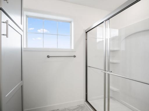 Owner's bath with shower and windows for natural light