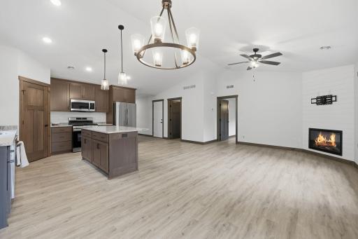Open layout with vinyl plank floors, vaulted ceilings, gorgeous lighting and recessed can lights, and shiplap fireplace!