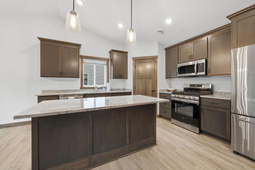 Center island with breakfast bar area for additional seating.. this floorplan allows space for entertaining!