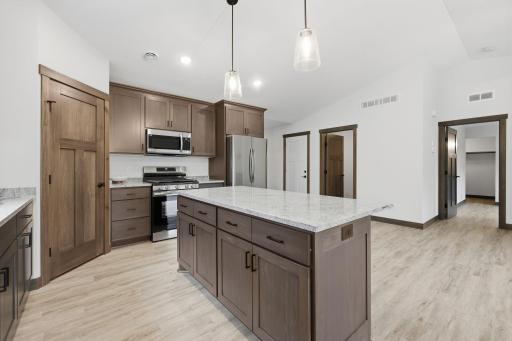 This LIKE NEW twin home offers ALOT of bang for the buck! Granite counters, SS appliances, vaulted ceilings, in-floor heat, and a corner pantry!!
