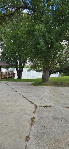 Large concrete pad/driveway with view of Lake