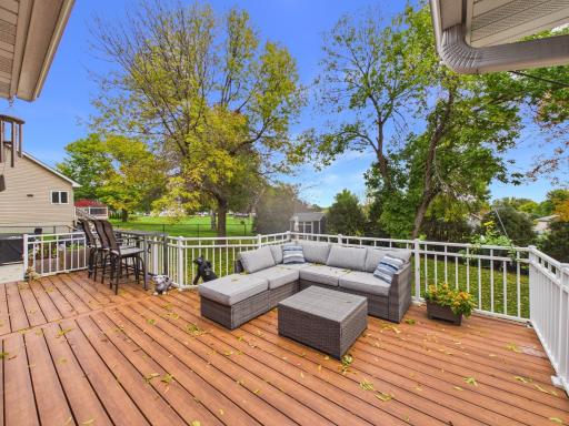 25 x 12 composite deck overlooking the fenced backyard and mature trees.
