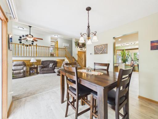 Dining area connected to the living room with large windows and backyard views.