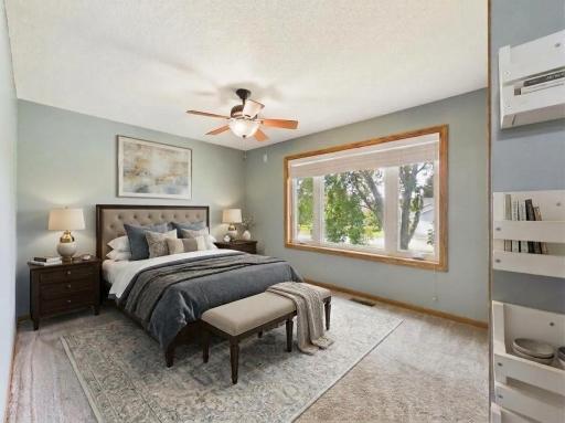 Virtually staged upper-level bedroom illustrating one possible furniture layout.
