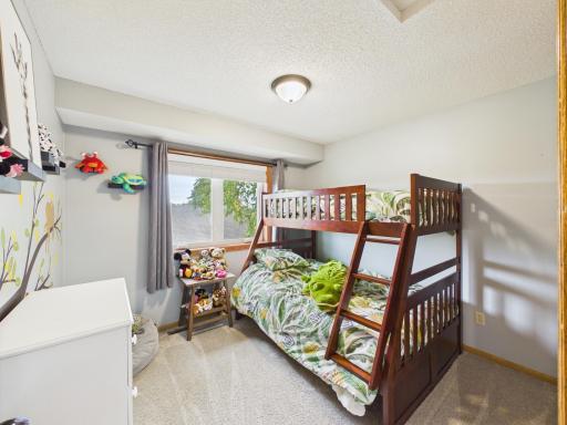 Upper-level bedroom with closet and window.