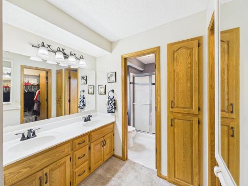 Primary suite bathroom with double-sink vanity and private access.