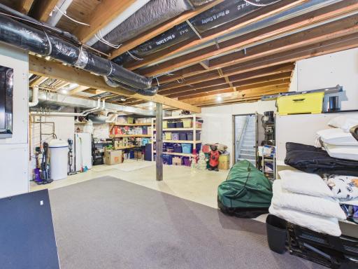 Lower-level storage area with shelving and utility space.