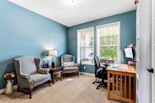 The front office provides a quiet, dedicated workspace separated from the central living areas, featuring large windows and natural light.