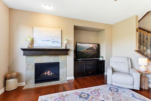 A gas fireplace with a stone surround adds warmth to the living room, creating a natural gathering space for cold Minnesota evenings