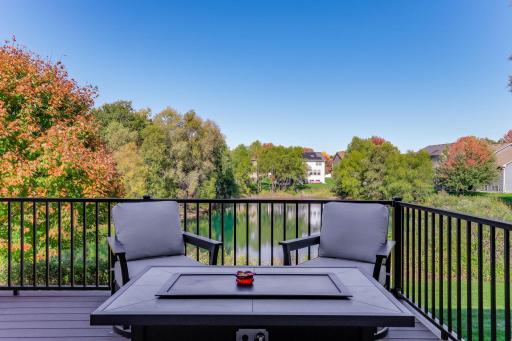 The composite deck extends the living space outdoors, offering a private, elevated vantage point to enjoy the pond and surrounding nature.