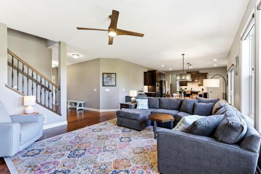 The open floor plan provides an uninterrupted transition between the living room, the informal dining area, and the kitchen.