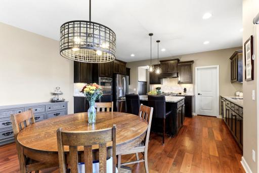 The informal dining area connects the kitchen to the outdoor living space, creating a natural flow for everyday meals and entertaining.