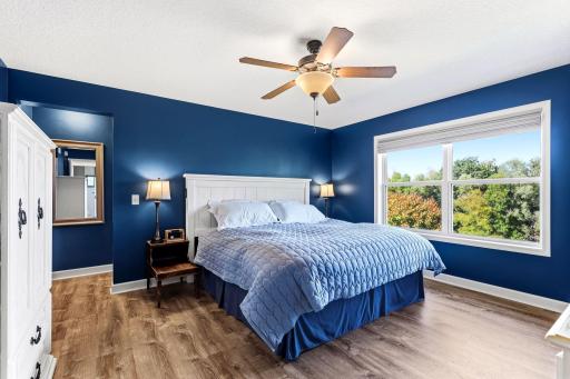 Step into the expansive primary suite, featuring large picture windows framing serene, private nature views.