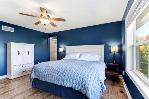 Abundant natural light fills the room, creating a bright atmosphere that perfectly complements the durable hard-surface flooring and spacious design