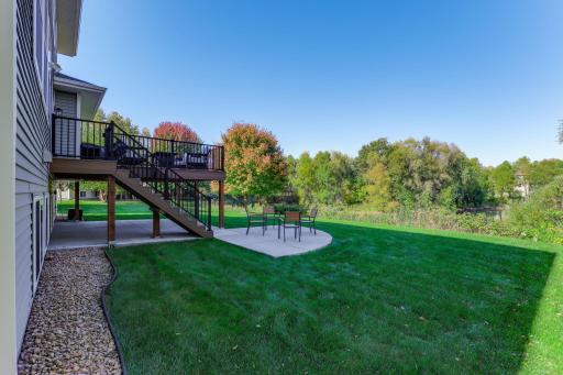Experience peaceful outdoor living from the patio and spacious elevated deck, perfectly positioned to take in the sprawling backyard and natural scenery beyond.